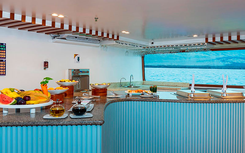 Dining area with food and panoramic view Galapagos catamaran