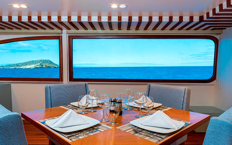 Indoor dining room and panoramic view for guests luxury catamaran