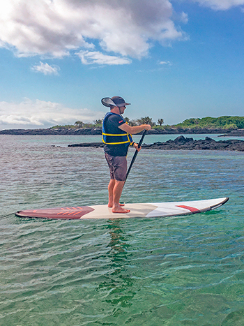 Paddle board activity in Galapagos ocean spray luxury catamaran