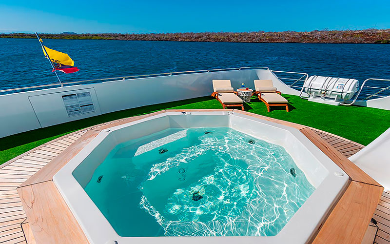 Sky deck which has a whirlpool and comfortable lounge chairs luxury catamaran Galapagos