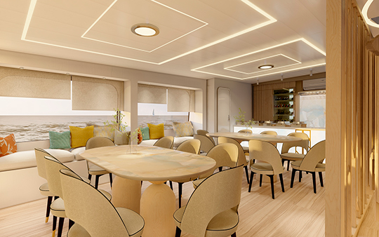 Comedor interior para 16 pasajeros con vista al oceano y bar en un catamaran de lujo