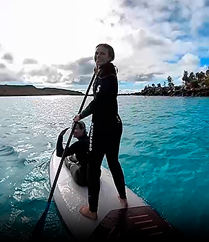 Passengers practicing paddle boarding on a luxury cruise to galapagos
