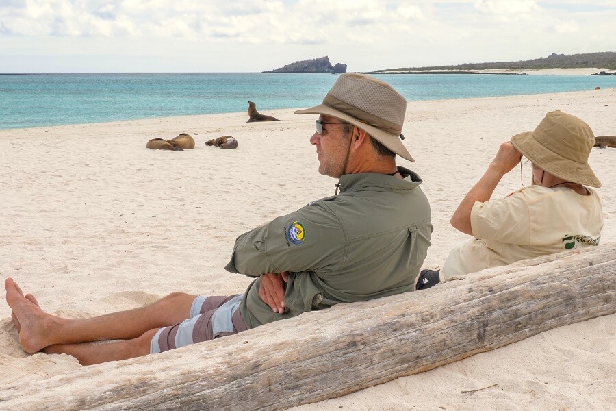 Travelers resting on one beach of the spectacular Galapagos islands_ecuador_and_galapagos_news